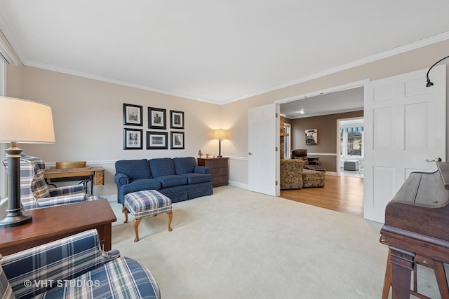 living room with crown molding, carpet, and baseboards