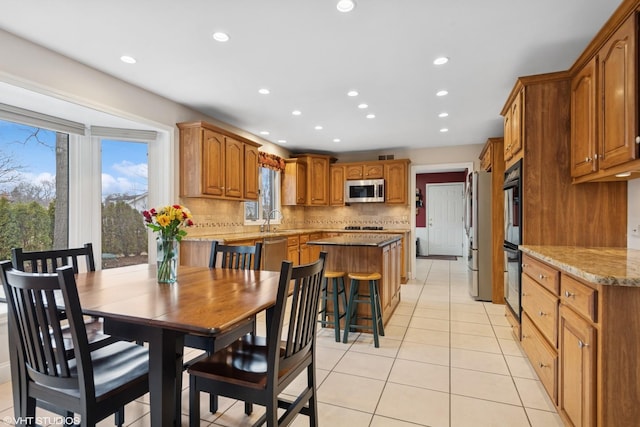 dining room with light tile patterned floors and recessed lighting