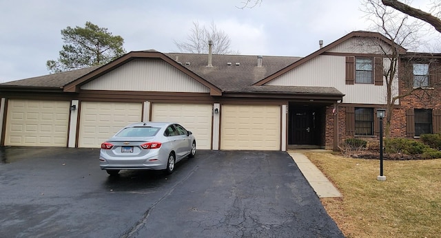 view of front of home with a front yard and a garage