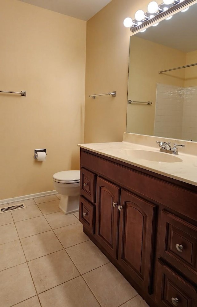 bathroom with a shower, tile patterned floors, vanity, and toilet