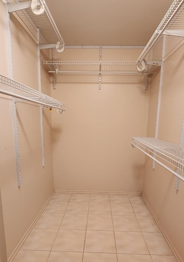 spacious closet featuring light tile patterned flooring