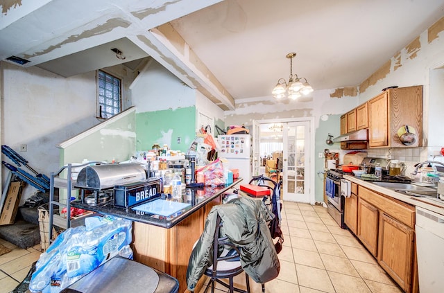 kitchen featuring pendant lighting, sink, white appliances, light tile patterned floors, and a notable chandelier