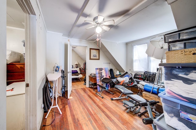 bonus room with hardwood / wood-style flooring, ceiling fan, and crown molding