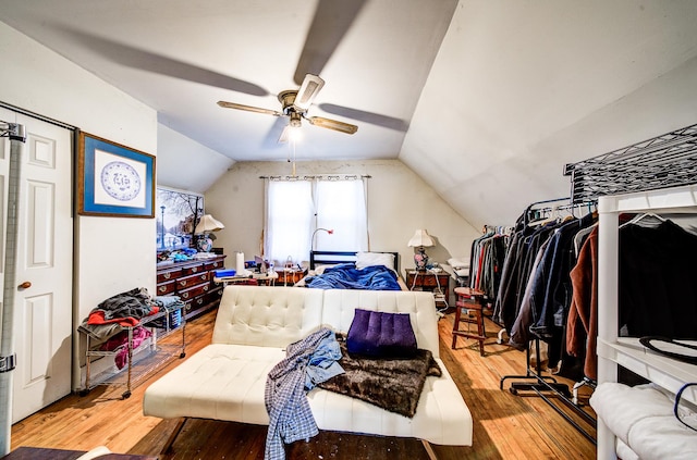 bedroom featuring hardwood / wood-style flooring, ceiling fan, and lofted ceiling