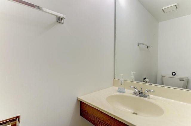 bathroom featuring toilet and vanity