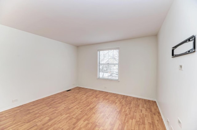 unfurnished room with light wood-type flooring