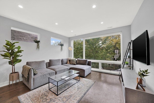 living area featuring recessed lighting, baseboards, and wood finished floors