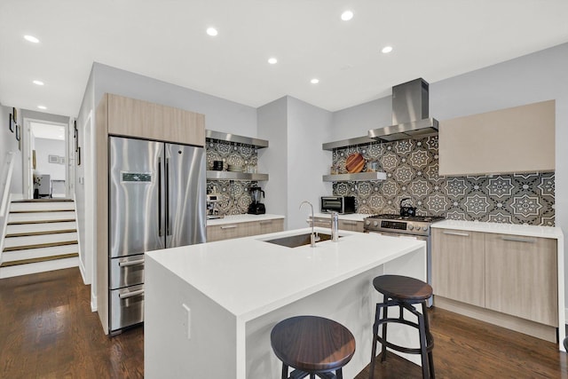 kitchen with open shelves, appliances with stainless steel finishes, a sink, modern cabinets, and wall chimney exhaust hood