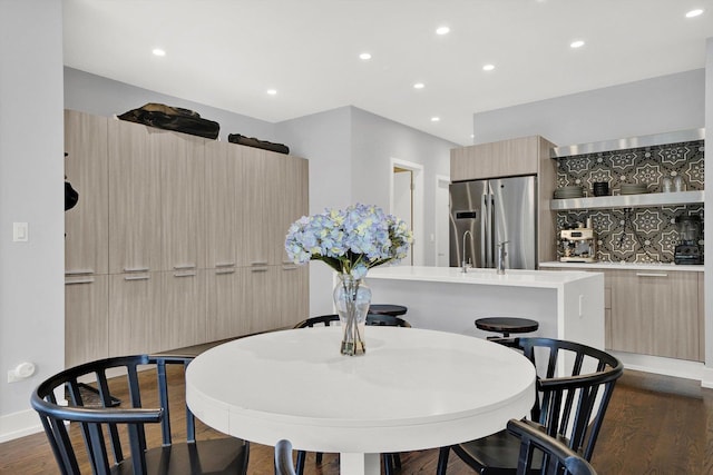 dining room featuring baseboards, dark wood-style flooring, and recessed lighting