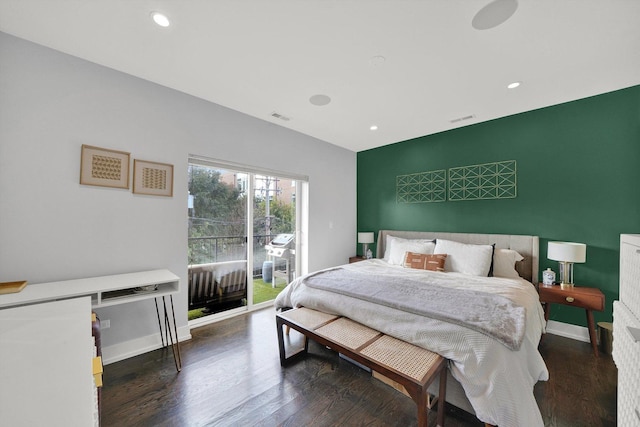 bedroom with access to outside, visible vents, baseboards, and wood finished floors