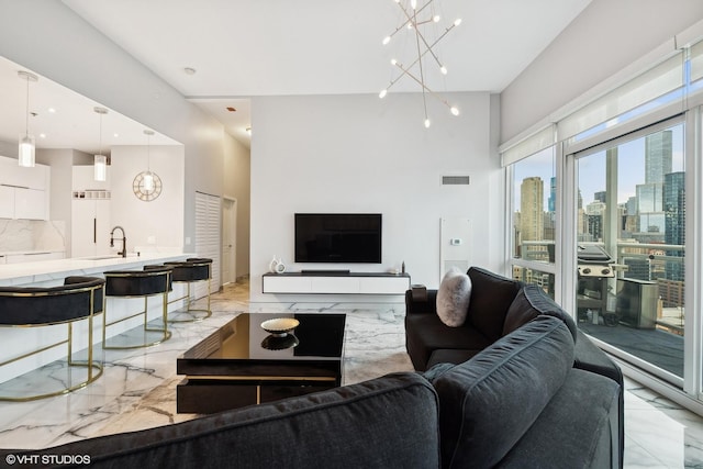 living room with sink and a notable chandelier