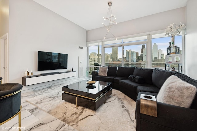 living room with a notable chandelier and a towering ceiling