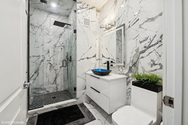 bathroom featuring a shower with door, vanity, and toilet