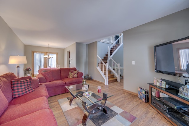 living room featuring a notable chandelier and light hardwood / wood-style floors