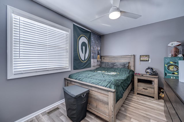 bedroom with ceiling fan and light hardwood / wood-style flooring