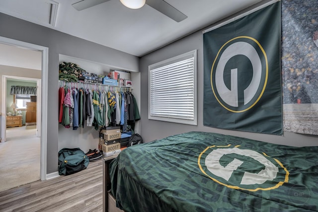 bedroom featuring hardwood / wood-style floors, ceiling fan, and a closet