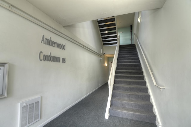 stairs with baseboards, visible vents, and carpet flooring