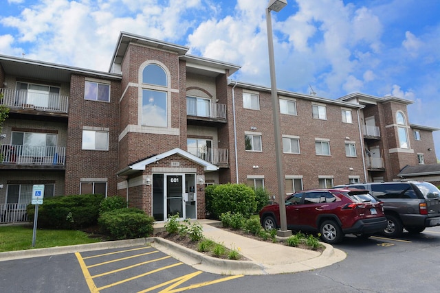 view of building exterior with uncovered parking