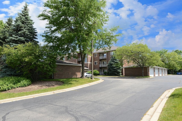 view of street with curbs and community garages