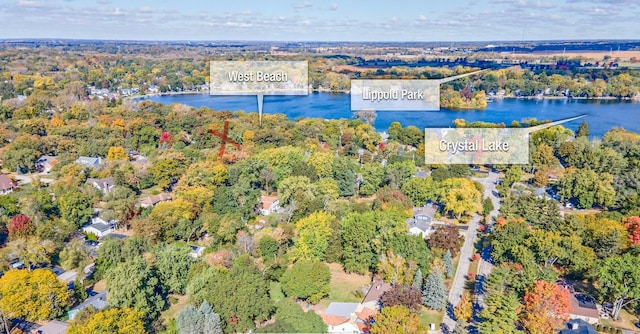 aerial view featuring a water view and a forest view