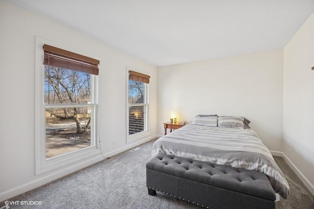 carpeted bedroom featuring baseboards