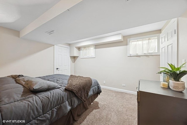 bedroom featuring carpet floors, visible vents, and baseboards