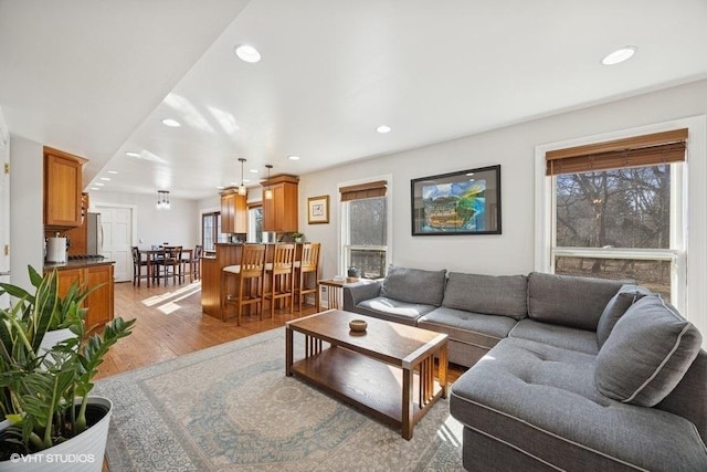 living room featuring light wood-type flooring and recessed lighting