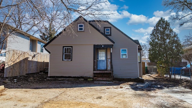 back of house with entry steps and fence