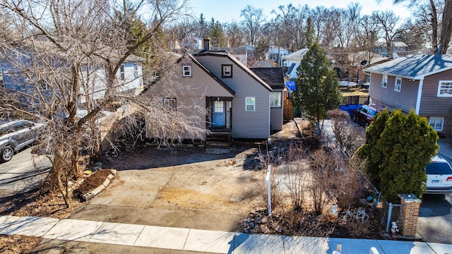 view of front facade featuring a residential view and fence