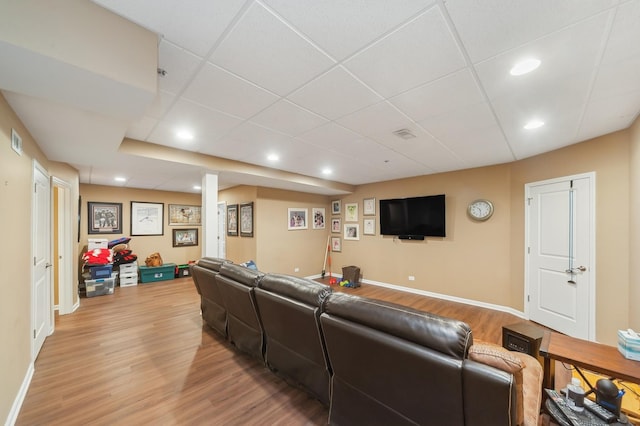 living room with a paneled ceiling, light wood-style flooring, baseboards, and recessed lighting