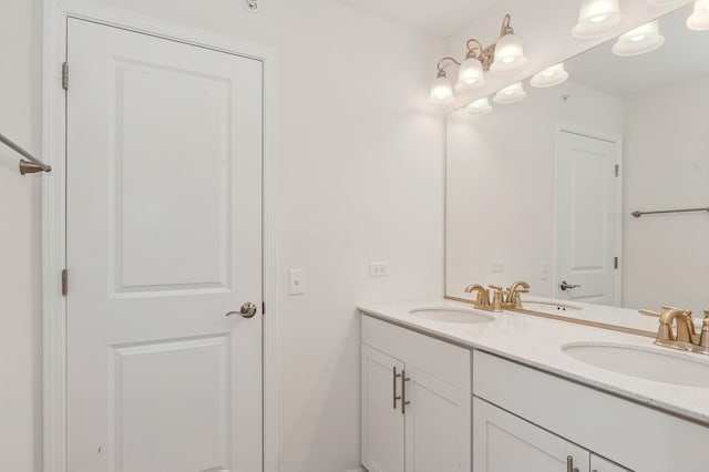 full bathroom featuring double vanity and a sink