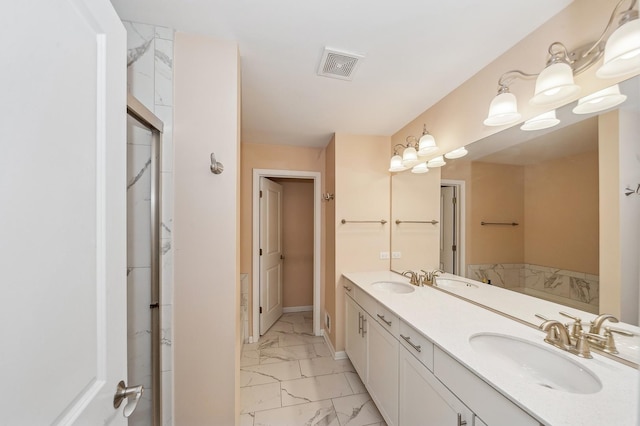 full bath with double vanity, marble finish floor, visible vents, and a sink