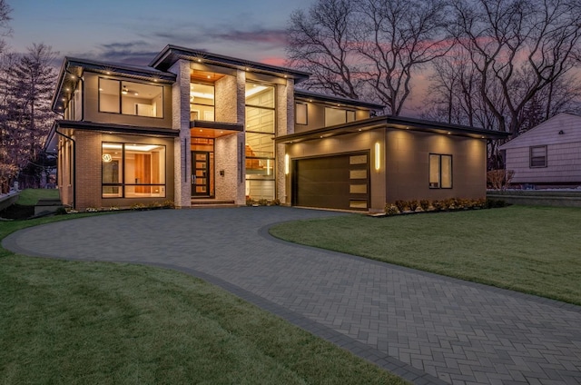 contemporary home with a yard and a garage