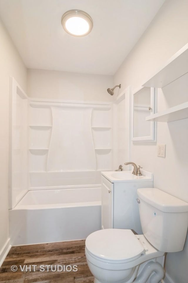 full bathroom featuring toilet, wood-type flooring, bathtub / shower combination, and vanity