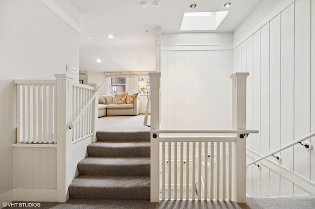 staircase with carpet flooring, recessed lighting, and a skylight