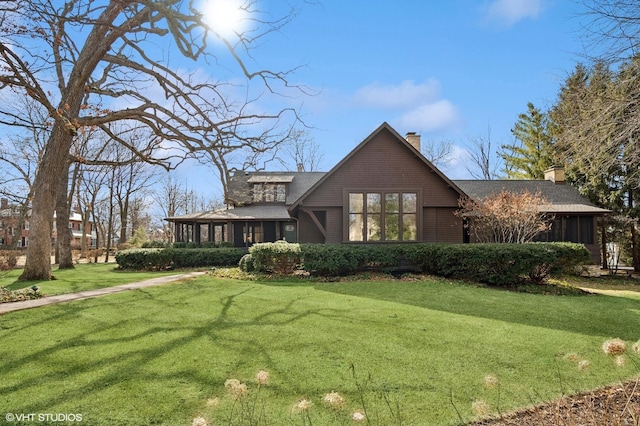 view of front of property featuring a front yard and a chimney