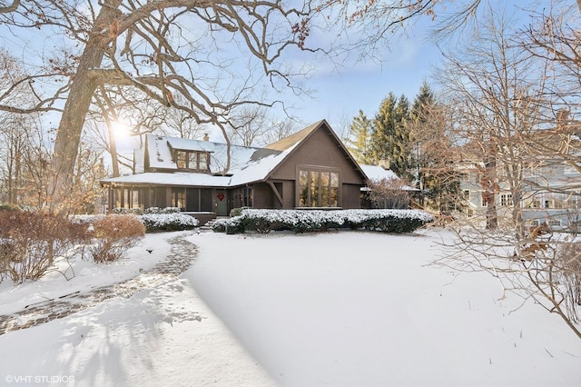 view of front of house featuring a chimney and a sunroom