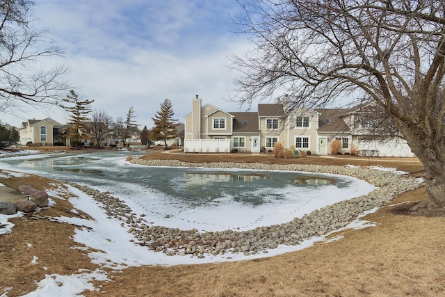 snow covered property featuring a chimney