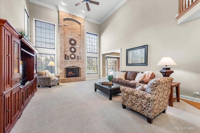 living room featuring a high ceiling, ornamental molding, a brick fireplace, light carpet, and baseboards