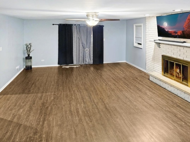 unfurnished living room with hardwood / wood-style floors, a brick fireplace, and ceiling fan