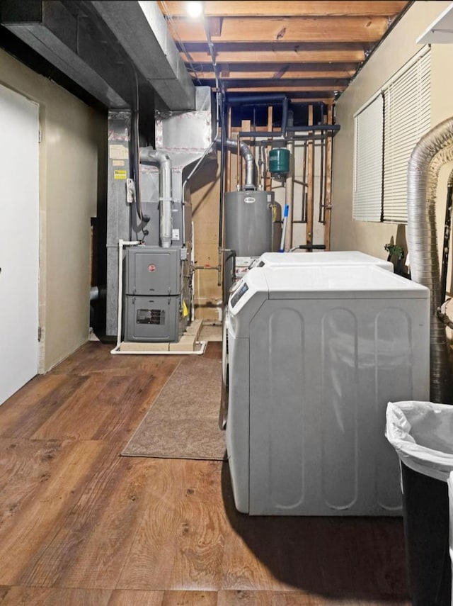 interior space with dark wood-type flooring, washing machine and clothes dryer, water heater, and heating unit