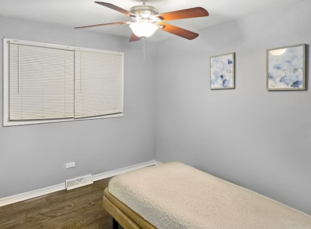 bedroom with ceiling fan and dark hardwood / wood-style flooring