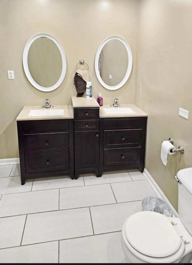 bathroom with vanity, tile patterned floors, and toilet