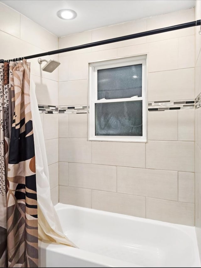 bathroom featuring shower / bathtub combination with curtain