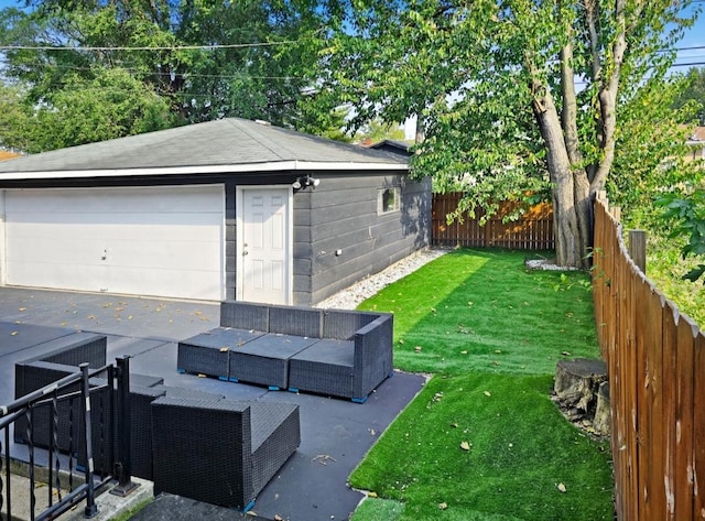 view of yard featuring an outdoor living space, a garage, and an outdoor structure