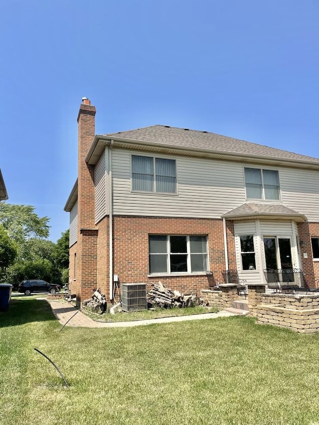 427 W Natoma Ave, Addison, IL 60101 - back of property featuring a chimney, a yard, and brick siding