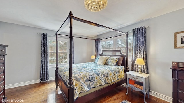 bedroom with dark wood-type flooring