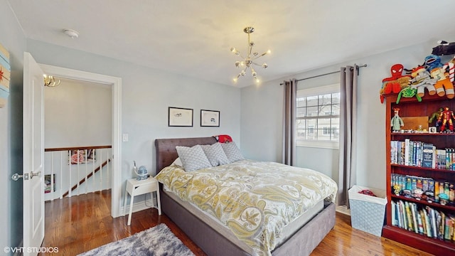 bedroom featuring hardwood / wood-style flooring and a chandelier