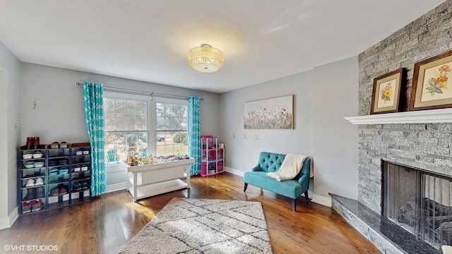 living area featuring hardwood / wood-style floors and a fireplace