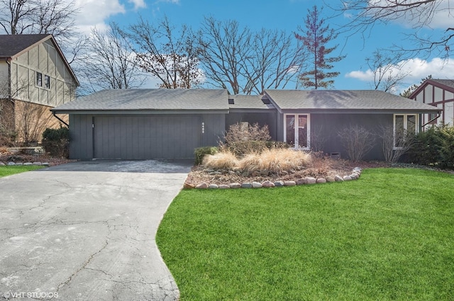 view of front of house with a garage and a front lawn